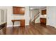 Kitchen desk with granite counters, hardwood floors and view of the stairway at 2055 Hickory Station Cir, Snellville, GA 30078