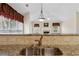 Kitchen sink with granite counters and view to the Gathering room with fireplace at 2055 Hickory Station Cir, Snellville, GA 30078