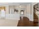 Open-concept layout featuring wainscoting and a view into the bright living room from the hardwood entry at 2055 Hickory Station Cir, Snellville, GA 30078