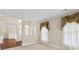 Elegant living room with decorative molding, neutral paint, and large windows with decorative valances at 2055 Hickory Station Cir, Snellville, GA 30078