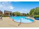 Community pool with lounge chairs and well-maintained landscaping at 2055 Hickory Station Cir, Snellville, GA 30078