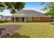 Spacious backyard and brick exterior with covered porch supported by pillars, offering an ideal outdoor living space at 2055 Hickory Station Cir, Snellville, GA 30078