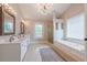 Elegant bathroom with double vanity, soaking tub, and glass shower at 4960 Cinnabar Dr, Alpharetta, GA 30022