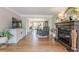 Cozy living room features fireplace, hardwood floors and open access to dining area at 4960 Cinnabar Dr, Alpharetta, GA 30022