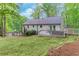 The backyard features a charming deck, beautiful landscaping, and plenty of space for outdoor activities at 607 Hickory Creek Ln, Woodstock, GA 30188