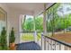Welcoming front porch with beautiful outdoor views and black accents on railings at 607 Hickory Creek Ln, Woodstock, GA 30188