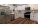 Well-lit kitchen featuring stainless steel appliances and white cabinets at 607 Hickory Creek Ln, Woodstock, GA 30188