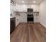Modern kitchen featuring stainless steel appliances and sleek white cabinetry at 607 Hickory Creek Ln, Woodstock, GA 30188