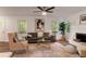 A cozy living room with stylish furniture and a ceiling fan for added comfort at 607 Hickory Creek Ln, Woodstock, GA 30188
