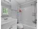 A well-lit bathroom features white tiling in the shower, a white vanity, toilet, and grey walls at 980 Oakton Sw Dr, Marietta, GA 30060