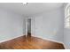 A bright bedroom features a hardwood floor, gray walls, a window, and white doors at 980 Oakton Sw Dr, Marietta, GA 30060