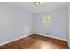 Empty bedroom with hardwood floors and natural light from one window at 980 Oakton Sw Dr, Marietta, GA 30060