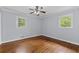 An airy bedroom features a hardwood floor, gray walls, white trim and a ceiling fan with lights at 980 Oakton Sw Dr, Marietta, GA 30060
