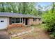 Charming brick home with black shutters, a stone path, and a lovely front yard at 980 Oakton Sw Dr, Marietta, GA 30060