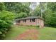 Brick home with an attached garage and lush lawn showcases classic suburban charm at 980 Oakton Sw Dr, Marietta, GA 30060