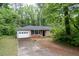 A cozy brick house with a well-maintained lawn and an attached garage providing convenient parking at 980 Oakton Sw Dr, Marietta, GA 30060