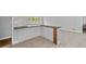 A kitchen pass-through with stone countertop and neutral colored tiled flooring at 980 Oakton Sw Dr, Marietta, GA 30060