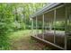 The screened-in porch offers outdoor living with its wooded views at 980 Oakton Sw Dr, Marietta, GA 30060