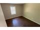 Cozy bedroom featuring hardwood floors and a window that provides natural light at 2888 Mountain View Rd, Snellville, GA 30078