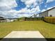 Large backyard featuring a concrete patio, newly installed wooden fence, and ample green space at 4935 Bellehurst Ln, Cumming, GA 30040