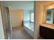 Relaxing bathroom showcasing a soaking tub, double vanity, and natural light at 4935 Bellehurst Ln, Cumming, GA 30040