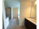 Bathroom view featuring a glass-enclosed shower and a double vanity at 4935 Bellehurst Ln, Cumming, GA 30040