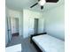 Cozy bedroom featuring a ceiling fan, closet, and carpeted floors at 4935 Bellehurst Ln, Cumming, GA 30040