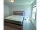 Bedroom featuring a large window, neutral carpet, and a stylish headboard at 4935 Bellehurst Ln, Cumming, GA 30040