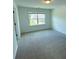 Bright bedroom with a large window and neutral carpeting at 4935 Bellehurst Ln, Cumming, GA 30040