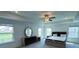 Bright bedroom features a tray ceiling, ceiling fan and many windows letting in lots of light at 4935 Bellehurst Ln, Cumming, GA 30040