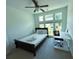 Bright bedroom features a ceiling fan and large windows for ample natural light at 4935 Bellehurst Ln, Cumming, GA 30040