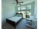 Bright bedroom features a ceiling fan, large windows, and white desk area at 4935 Bellehurst Ln, Cumming, GA 30040