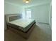 Bedroom featuring large window, carpeted floors, and a queen-size bed at 4935 Bellehurst Ln, Cumming, GA 30040