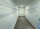 Spacious walk-in closet with shelving for organized storage in a modern home at 4935 Bellehurst Ln, Cumming, GA 30040