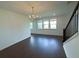 Dining room with modern chandelier, large windows, and hardwood floors at 4935 Bellehurst Ln, Cumming, GA 30040