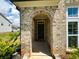 Arched brick entryway leading to front door at 4935 Bellehurst Ln, Cumming, GA 30040
