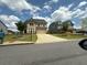 Charming brick home with a two-car garage, landscaped yard, and long concrete driveway at 4935 Bellehurst Ln, Cumming, GA 30040