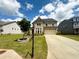 Charming brick two-story home with a well-manicured lawn and a long driveway at 4935 Bellehurst Ln, Cumming, GA 30040