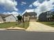 Beautiful two-story brick home with a well-maintained lawn and a concrete driveway at 4935 Bellehurst Ln, Cumming, GA 30040
