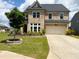 Attractive brick home featuring an attached two-car garage and a landscaped front yard at 4935 Bellehurst Ln, Cumming, GA 30040