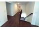 Hallway with hardwood floors leading to the staircase at 4935 Bellehurst Ln, Cumming, GA 30040