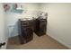 Well-lit laundry room with modern, front-loading washer and dryer at 4935 Bellehurst Ln, Cumming, GA 30040