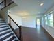 Living room featuring hardwood floors, staircase, and abundant natural light at 4935 Bellehurst Ln, Cumming, GA 30040