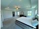 Spacious main bedroom with a ceiling fan, lots of natural light, and a tray ceiling at 4935 Bellehurst Ln, Cumming, GA 30040
