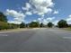 Community parking lot with playground, green space, and homes in the background on a sunny day at 4935 Bellehurst Ln, Cumming, GA 30040