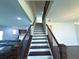 Beautiful staircase with wood railing and white risers leading to the upper level of the home at 4935 Bellehurst Ln, Cumming, GA 30040