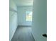 Walk-in closet with carpet flooring, wire shelving, and a window for natural light at 4935 Bellehurst Ln, Cumming, GA 30040