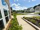 Sidewalk bordered by trimmed green bushes and flowering plants at 4935 Bellehurst Ln, Cumming, GA 30040