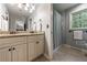 Elegant bathroom with double vanity, granite countertops, and a shower with decorative curtain at 4311 N Elizabeth Se Ln, Atlanta, GA 30339
