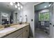 Well-lit bathroom with double sinks, granite countertop and shower with coordinating neutral tile at 4311 N Elizabeth Se Ln, Atlanta, GA 30339